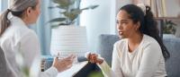 woman talking to a woman therapist in light filled room